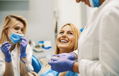 dental team talking with smiling patient