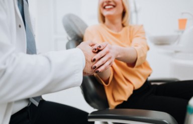 dental team talking with smiling patient