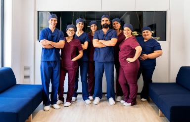 dental team talking with smiling patient