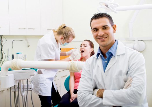 dentist smiling in dental exam room